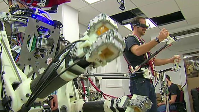 Check It Out: Biped robot mimics actions of human operator