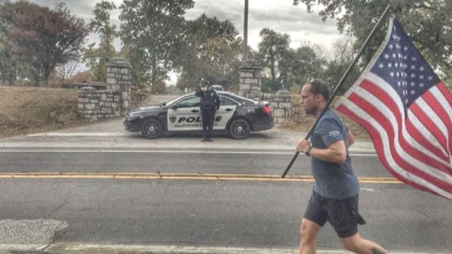 Viral photo captures police paying respects to Old Glory
