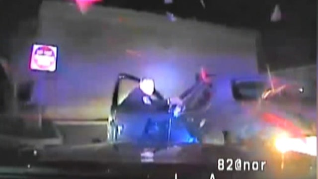 Woman slams reversing car into arresting cop