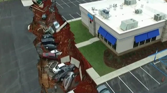 Parking lot collapse swallows up a dozen cars at IHOP