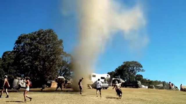 Concert-goers dance with dust devil ripping through festival