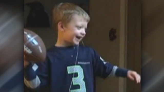 Little football fan tosses pigskin to pull loose tooth