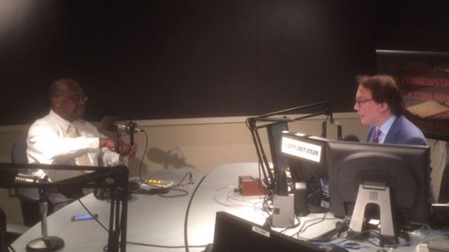 Alan Colmes and Herman Cain