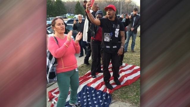 Protesters trample American flag outside Trump rally