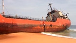 Ghost ship gutted by fire washes ashore in Liberia