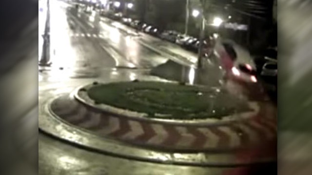 Speeding car hits traffic circle, flies through air