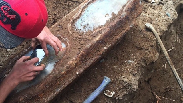 Century-old coffin with child's remains found under garage