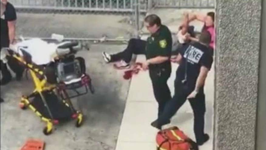 Raw video: First responders attend to victim of shooting at Fort Lauderdale-Hollywood International Airport