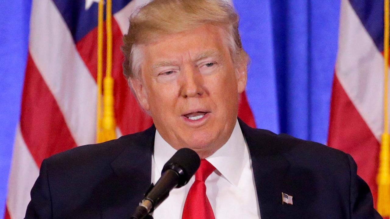 Trump blasts Russia reports, unveils plan for business empire at feisty news conference