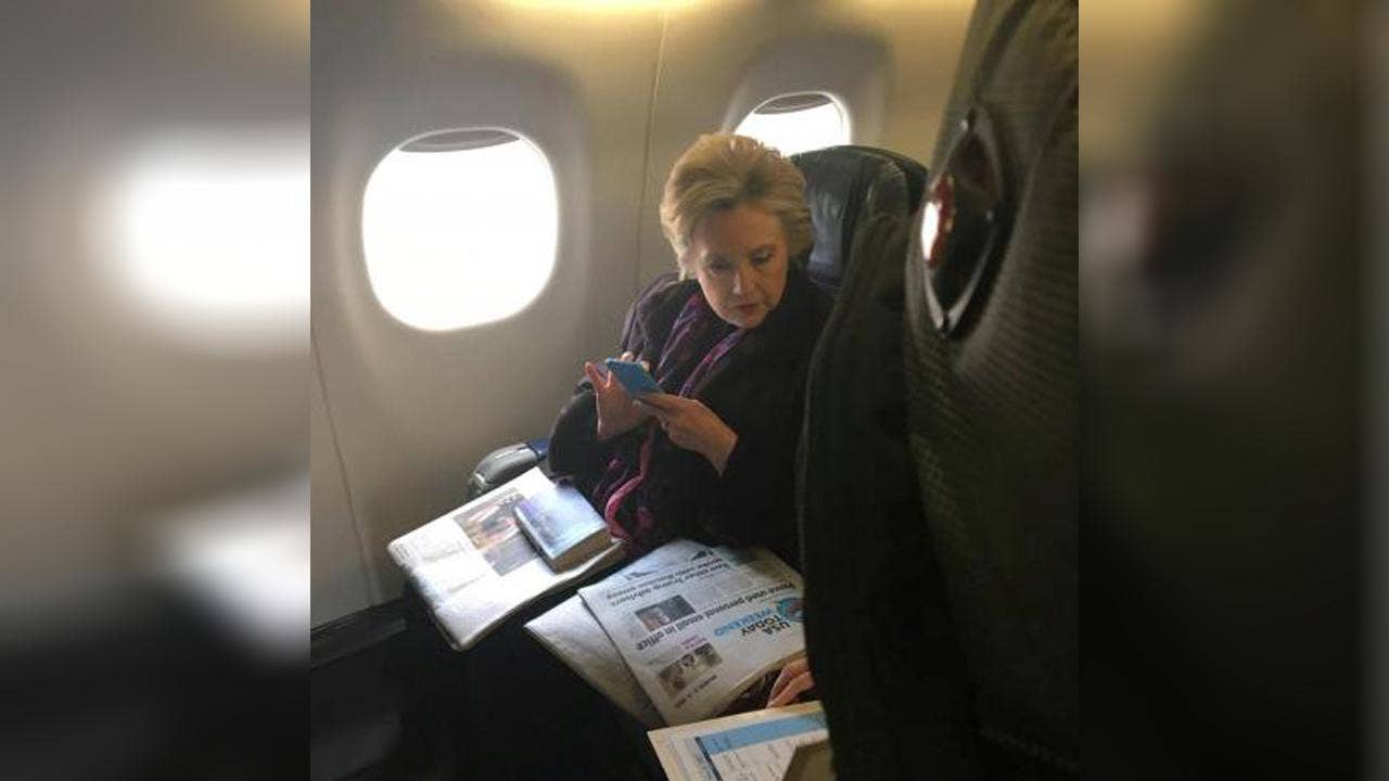 Picture catches Clinton reading newspaper story about Pence emails