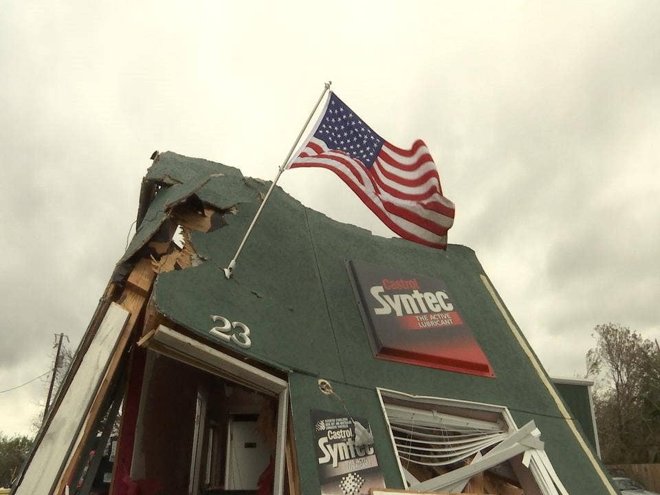 "We'll rebuild" &mdash; Rockport residents hang Old Glory on collapsed buildings to show strength after Harvey