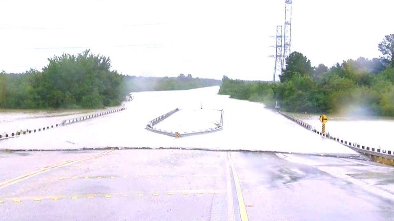 Harvey floodwaters overflow Houston reservoir, separate levee breach reported