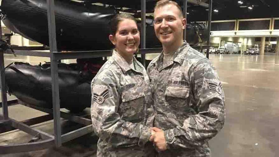 After their beach wedding was cancelled due to Hurricane Irma, a deployed National Guard couple decided to exchange vows in a hanger wearing fatigues