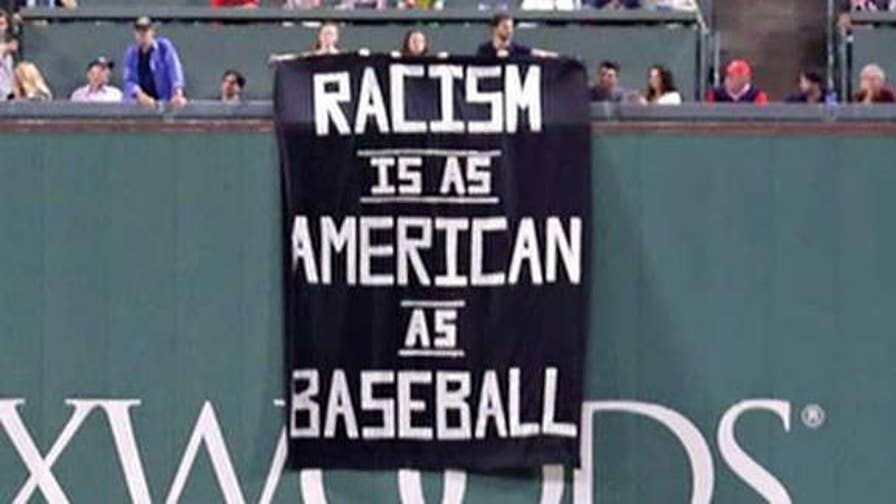 Boston Red Sox Fans Hang Racism Is As American As Baseball Sign Above Green Monster During