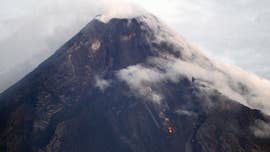 A bright red burst of lava that spurted like a fountain and flowed down the side of the Philippines’ most active volcano sent more villagers scrambling for safety Tuesday, as officials warned tourists from entering the danger zone.