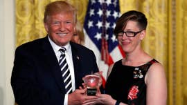 A Washington state educator, the recipient of the National Teacher of the Year award, may have attempted to send a silent message of protest when she was presented the trophy by President Donald Trump Wednesday afternoon.
