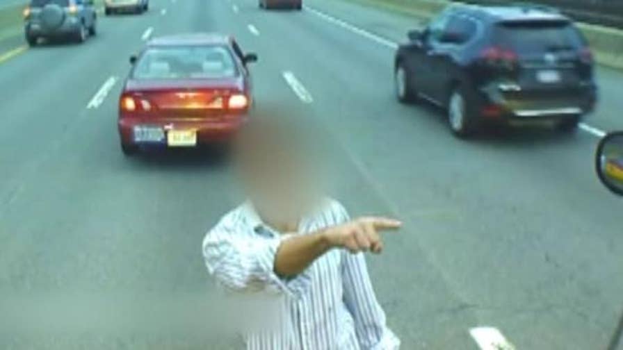 Man parks car on Massachusetts Turnpike, climbs onto the hood of school bus.