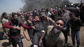 At least three of the 52 Palestinians reportedly killed Monday in clashes ahead of the Jerusalem opening of the U.S. Embassy to Israel were “armed terrorists” caught trying to plant a bomb near the Gaza border fence, Israel's military said.