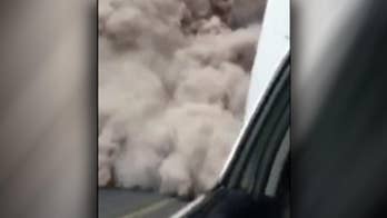 Raw video shows Guatemalan police fleeing the rapidly expanding ash cloud from a volcanic eruption.
