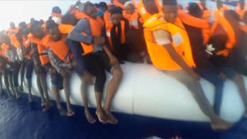 Raw video: German NGO Mission Lifeline shares footage of operators rescuing mother and child from crowded dinghy in the Mediterranean.