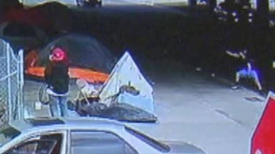 Security footage shows a man fire shots at a Los Angeles homeless encampment.