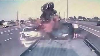 Car slams into an SUV stranded on a busy highway in Toronto.