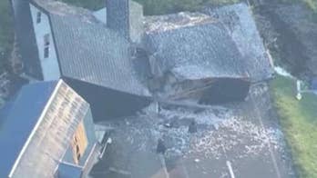 Rescuers scramble to save people trapped under rubble.

