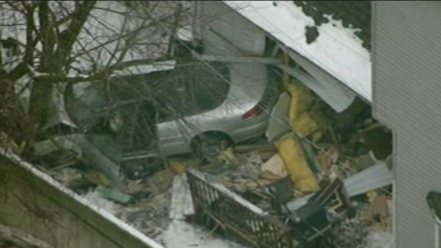 Out-of-control car crashes through house