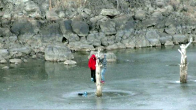 Teens trapped on icy lake cling to tree for four hours 
