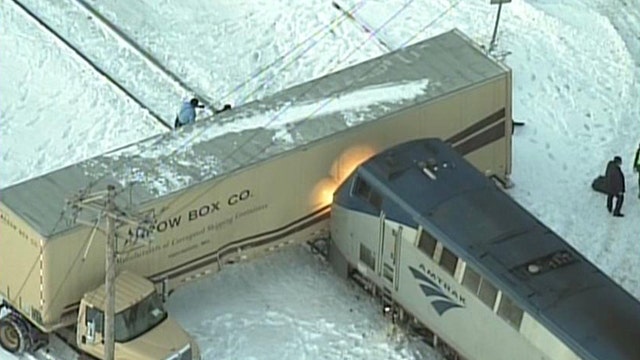 Close call: Amtrak train hits semi stuck on tracks