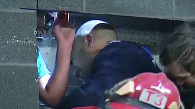 Firefighter describes rescuing woman stuck between walls