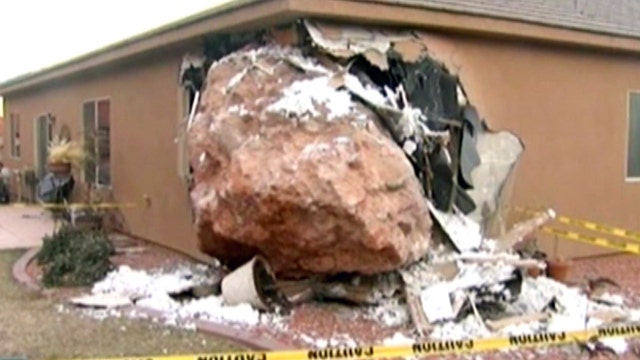 Boulder crashes into home, injures woman