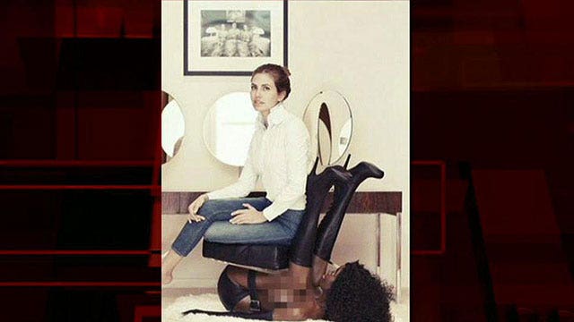 Editor sparks anger after posing on 'black woman chair'