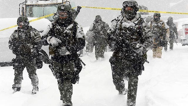 Snow helping, hurting manhunt for cop-killer