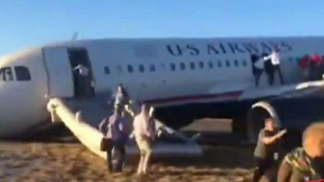 Passengers flee plane after landing gear blows out