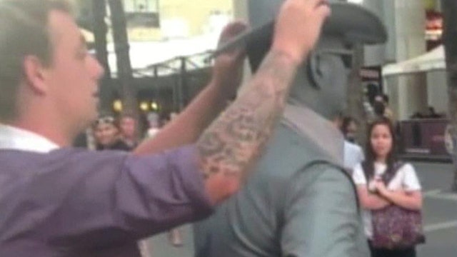 Street performer punches man