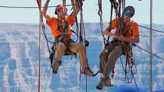 Window cleaners dangle above Grand Canyon
