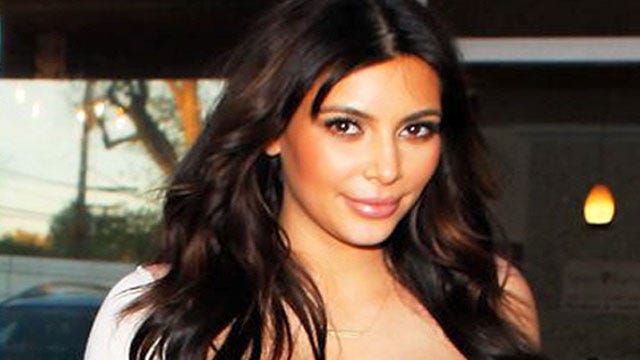 Kim busts out of maternity dress