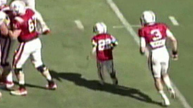 7 year old cancer patient takes the field with Nebraska team