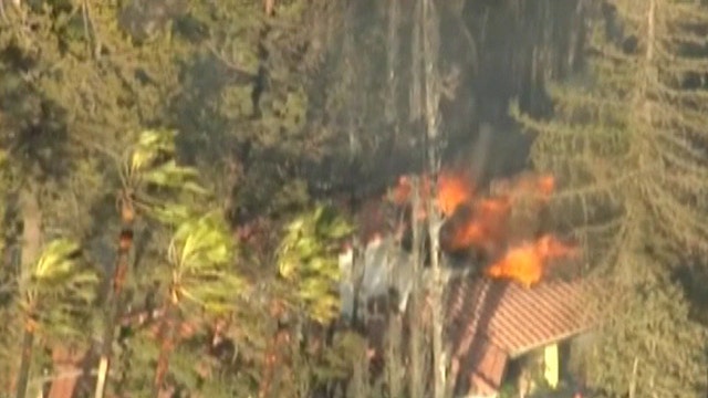 Across America: Fast-moving wildfire threatens homes