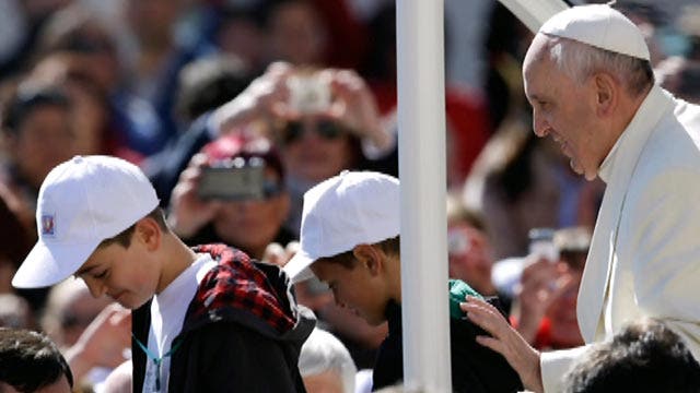 Kids catch a ride on the Pope-mobile 