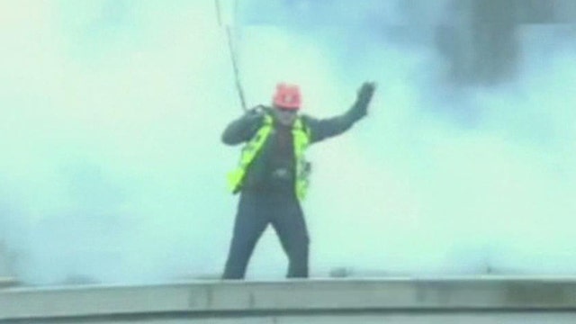 Building demolished with man on roof