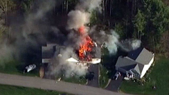 Police officer shot, killed before home explodes