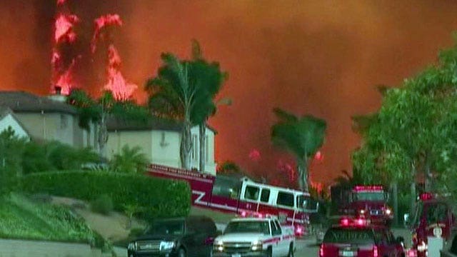 Hundreds of firefighters battle raging wildfires