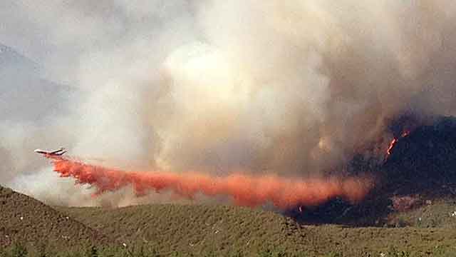 Firefighters battle to contain massive wildfire