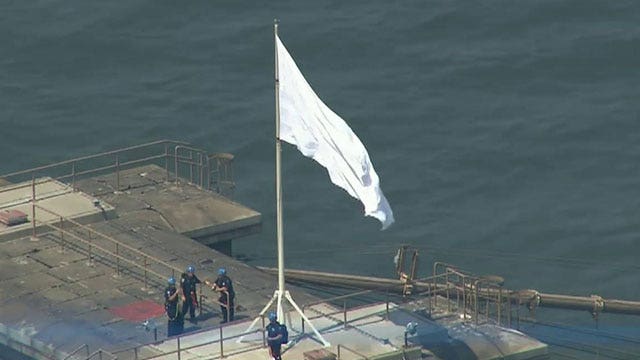 Symbolic danger of white flags over Brooklyn Bridge