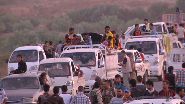 Thousands flee after ISIS militants seize towns in Iraq