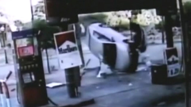 Car flips into gas station