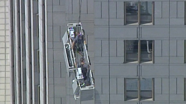 Window washers rescued after scaffolding breaks