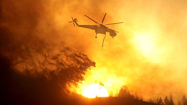 Firefighters battle to contain western wildfires